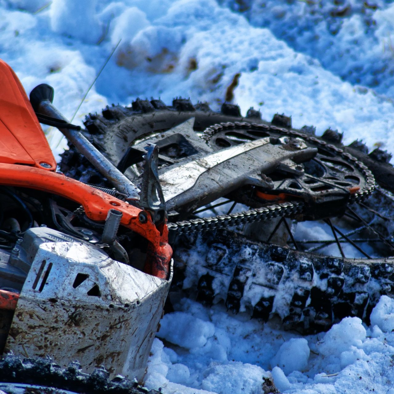 orange and black snow blower on snow covered ground